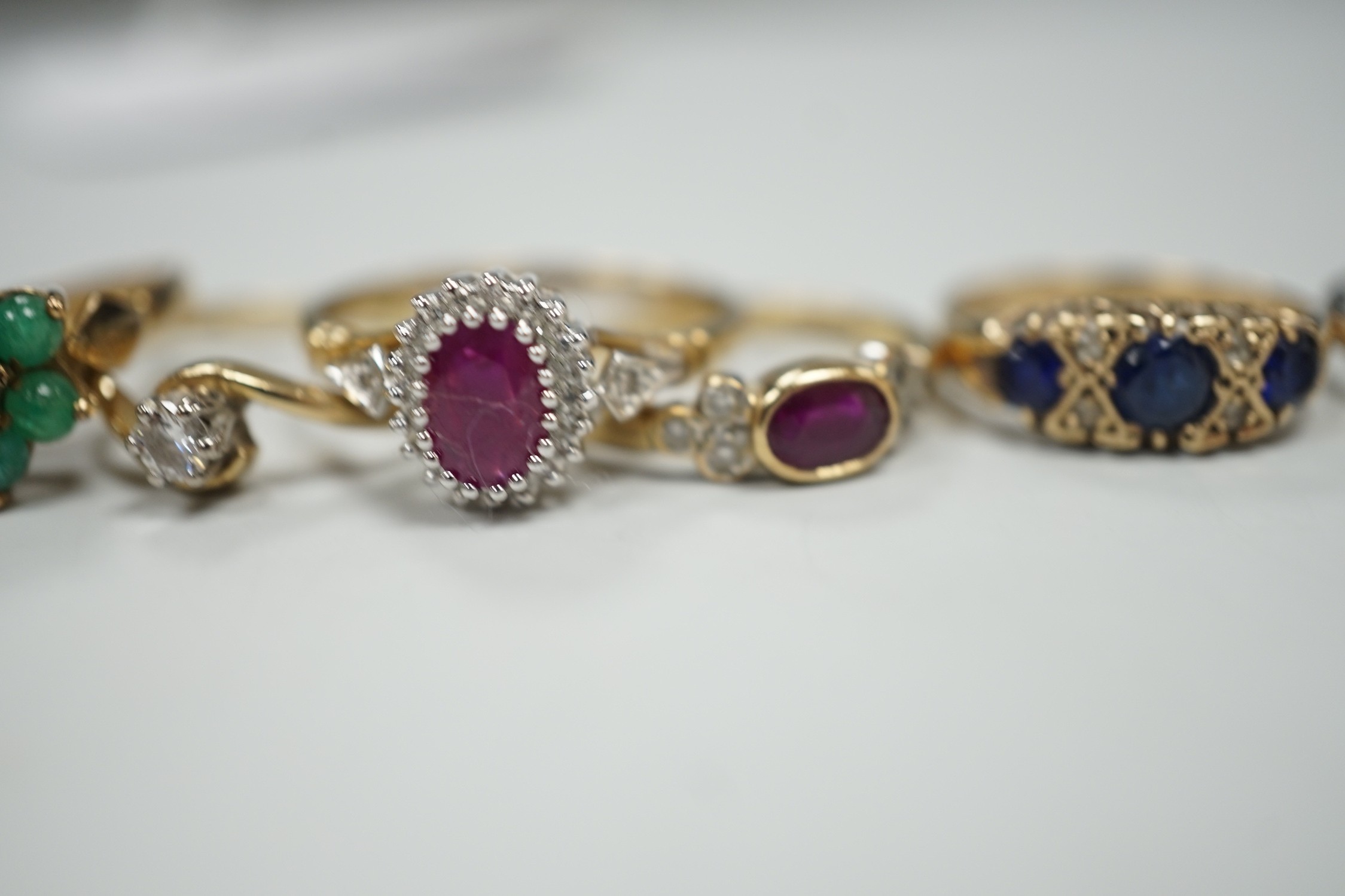 Seven assorted modern 9ct gold and gem set rings, including two solitaire diamond rings, together with a 9ct gold and amber set pendant, gross weight 19.3 grams.